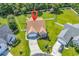 Aerial view of a well-maintained home with a manicured lawn, a long driveway, and mature landscaping at 824 Dunoway Ct., Myrtle Beach, SC 29579