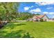 Expansive backyard featuring a well-maintained lawn, patio with furniture, and a playhouse, ideal for outdoor enjoyment at 824 Dunoway Ct., Myrtle Beach, SC 29579