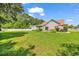 Expansive backyard featuring a well-maintained lawn, patio with furniture, and lush landscaping at 824 Dunoway Ct., Myrtle Beach, SC 29579
