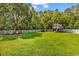 Serene backyard featuring a spacious lawn, a playhouse, and mature trees offering plenty of shade at 824 Dunoway Ct., Myrtle Beach, SC 29579