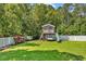 Well-maintained backyard with a charming playhouse, lush greenery, and a secure white fence at 824 Dunoway Ct., Myrtle Beach, SC 29579