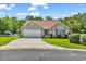 Charming single-story home with a well-manicured lawn, a two-car garage, and mature trees at 824 Dunoway Ct., Myrtle Beach, SC 29579