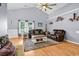 Bright living room featuring vaulted ceilings, hardwood floors, and comfortable seating area at 824 Dunoway Ct., Myrtle Beach, SC 29579