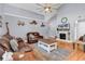 Cozy living room with vaulted ceilings, hardwood floors, a fireplace, and a ceiling fan at 824 Dunoway Ct., Myrtle Beach, SC 29579