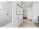 Modern bathroom with a tiled shower, sleek hardware, and a view to a walk-in closet, offering a luxurious space at 866 Fowler Rd., Conway, SC 29526