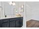 Elegant bathroom featuring a dark vanity with a white countertop, a golden faucet, and access to the walk-in closet at 866 Fowler Rd., Conway, SC 29526