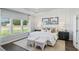 Stylish bedroom with tray ceiling, hardwood floors, white walls, plush bedding, and large windows with beautiful outdoor view at 866 Fowler Rd., Conway, SC 29526