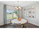Bright dining room with a round table, six chairs, large windows, and modern decor at 866 Fowler Rd., Conway, SC 29526