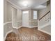 Inviting foyer boasts gleaming hardwood floors, elegant staircase, and neutral paint scheme, creating a warm and welcoming ambiance at 866 Fowler Rd., Conway, SC 29526