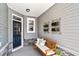 Inviting front porch with a wooden bench, stylish planters, and a blue front door, creating a cozy entrance at 866 Fowler Rd., Conway, SC 29526