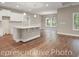 Bright kitchen features white cabinets, stainless steel appliances, an island with bar seating, and hardwood flooring at 866 Fowler Rd., Conway, SC 29526