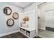 Stylish mudroom with built-in bench, storage baskets, hooks, and decorative mirrors at 866 Fowler Rd., Conway, SC 29526