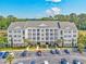 Beautiful condo exterior with ample parking, manicured landscaping, and building with multiple units at 901 Knoll Shores Ct. # 304, Murrells Inlet, SC 29576