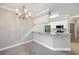 Kitchen with white cabinets, stainless appliances, marble countertops, and chandelier lighting at 901 Knoll Shores Ct. # 304, Murrells Inlet, SC 29576