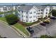 An aerial view of the condo community with a lake and landscaping showcasing the surrounding area at 901 West Port Dr. # 305, North Myrtle Beach, SC 29582