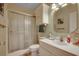 Bright bathroom features a shower-tub combo with glass doors and updated fixtures at 901 West Port Dr. # 305, North Myrtle Beach, SC 29582