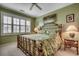 Comfortable bedroom with green walls, a decorative metal bed frame, and plenty of natural light at 901 West Port Dr. # 305, North Myrtle Beach, SC 29582