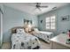 Comfortable bedroom with light blue walls, twin beds, and bright natural light from the shuttered window at 901 West Port Dr. # 305, North Myrtle Beach, SC 29582