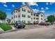 Three story condo building with parking and blue shutters with well-maintained landscaping at 901 West Port Dr. # 305, North Myrtle Beach, SC 29582