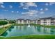 Scenic exterior view of the condo buildings overlooking a beautiful pond with fountain at 901 West Port Dr. # 305, North Myrtle Beach, SC 29582