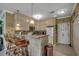 Kitchen area with an open breakfast bar featuring seating, granite counters and white appliances at 901 West Port Dr. # 305, North Myrtle Beach, SC 29582