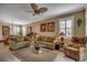 Inviting living room features neutral decor, plush sofas, ceiling fan, and seamless flow to dining area at 901 West Port Dr. # 305, North Myrtle Beach, SC 29582