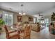 Living area with glass topped table and decorated in tropical style with access to patio at 901 West Port Dr. # 305, North Myrtle Beach, SC 29582