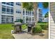 Outdoor grills available for residents' use, set amidst manicured landscaping at 901 West Port Dr. # 305, North Myrtle Beach, SC 29582
