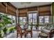 Bright sunroom with large windows, wicker furniture, and serene views of pond and landscaping at 901 West Port Dr. # 305, North Myrtle Beach, SC 29582