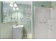 Bright bathroom featuring a vanity, mirror, window, and shower at 910 N Dogwood Dr., Surfside Beach, SC 29575