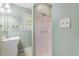 Bright bathroom featuring a vanity, mirror, window, and shower at 910 N Dogwood Dr., Surfside Beach, SC 29575
