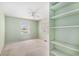Bright bedroom featuring two windows and a built-in shelving unit at 910 N Dogwood Dr., Surfside Beach, SC 29575