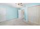 A light blue bedroom with a ceiling fan and a closet, ready for personalization at 910 N Dogwood Dr., Surfside Beach, SC 29575
