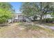 Charming stilt home featuring a screened porch, driveway, and lush surrounding trees at 910 N Dogwood Dr., Surfside Beach, SC 29575