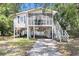 Charming stilt home featuring a screened porch and driveway at 910 N Dogwood Dr., Surfside Beach, SC 29575