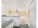 View from kitchen showing bright walls, an open living room with chandelier, and plenty of light at 910 N Dogwood Dr., Surfside Beach, SC 29575