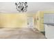 Inviting living room next to kitchen featuring bright walls, chandelier, and lots of natural light at 910 N Dogwood Dr., Surfside Beach, SC 29575