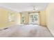 Living room with ceiling fan, doors to the outside and yellow walls at 910 N Dogwood Dr., Surfside Beach, SC 29575