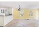Inviting living room with bright walls, view of kitchen with island, chandelier, and lots of windows at 910 N Dogwood Dr., Surfside Beach, SC 29575