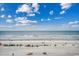 Beautiful beach view of people enjoying the white sand and ocean under a partly cloudy sky at 9400 Shore Dr. # 617, Myrtle Beach, SC 29572