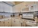 Bright kitchen features white cabinets, granite counters, and stainless appliances at 9400 Shore Dr. # 617, Myrtle Beach, SC 29572