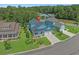 Aerial view of a blue two-story home with a two-car garage, nice landscaping, and a well-manicured lawn at 945 Waterbridge Blvd., Myrtle Beach, SC 29579