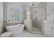 Modern bathroom with soaking tub, glass shower, and neutral tile at 945 Waterbridge Blvd., Myrtle Beach, SC 29579
