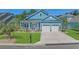 Charming blue home with white trim, a well-manicured lawn, and an attached two-car garage at 945 Waterbridge Blvd., Myrtle Beach, SC 29579