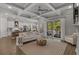 Open-concept living room flowing into kitchen, with coffered ceiling and sliding glass doors at 945 Waterbridge Blvd., Myrtle Beach, SC 29579
