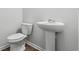 Cozy bathroom featuring a modern toilet and pedestal sink with classic fixtures at 1004 Kinness Dr., Conway, SC 29527