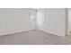 Neutral bedroom featuring soft carpet, a window with blinds, and a white door at 1004 Kinness Dr., Conway, SC 29527