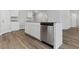 Modern kitchen island with granite countertop, stainless steel dishwasher, and white cabinets for a clean aesthetic at 1004 Kinness Dr., Conway, SC 29527