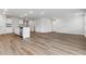 Bright, open-concept living area featuring wood floors, modern lighting, and a kitchen with stainless appliances at 1004 Kinness Dr., Conway, SC 29527