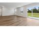 Bright living room with wood floors and sliding glass door to backyard providing ample natural light at 1004 Kinness Dr., Conway, SC 29527